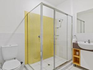 a bathroom with a shower and a toilet and a sink at South Shores Villa 59 in Normanville