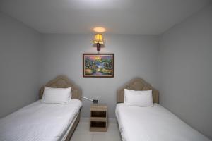 Postel nebo postele na pokoji v ubytování Kun Hotel