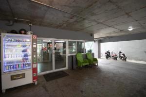 a room with a vending machine with motorcycles in the background at Kun Hotel in Nakhon Ratchasima