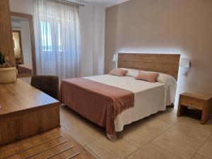 a bedroom with a large bed and a large window at Hotel Punta San Francesco in Vieste