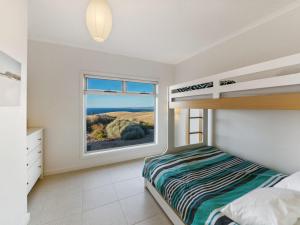 a bedroom with a bunk bed and a window at Fleurieu Coastal Retreat Lot 150 Myponga Beach in Wattle Flat