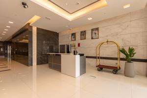 a lobby with a luggage cart in a building at Grand Stay Holiday Homes Rental in Dubai