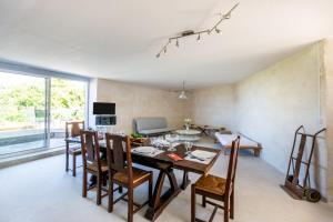a dining room and living room with a table and chairs at Blockhaus 44 in Ver-sur-Mer