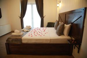 a bedroom with a large bed with red hearts on it at Sea House Hotel in Agva