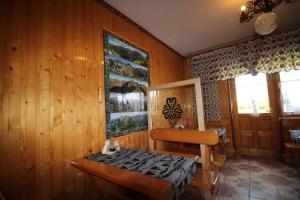 a room with a wooden wall with a bed and a table at DW U Wajdy in Białka Tatrzanska +254 photos