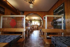 a dining room with wooden walls and tables and benches at DW U Wajdy in Białka Tatrzanska