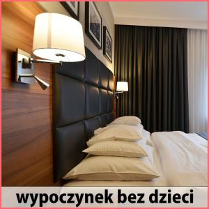 a bedroom with a bed with a black headboard and pillows at Villa Grace - wypoczynek bez dzieci in Szklarska Poręba