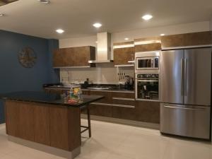 a kitchen with a stainless steel refrigerator and a counter at Business SUITES KEPLER in Mexico City