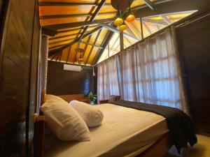 A bed or beds in a room at Compass Atauro Eco Lodge
