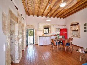 a kitchen and dining room with a table and chairs at Kambos House in Kimolos