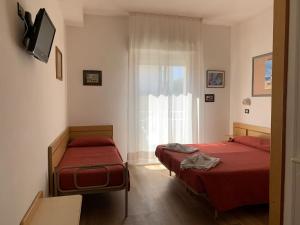 מיטה או מיטות בחדר ב-Hotel Tre Grazie