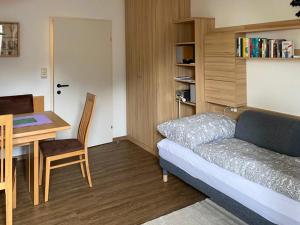 a living room with a couch and a table and a desk at Kirchengasse 162 - Alte Post II in Bad Aussee