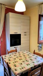 ein Esszimmer mit einem Tisch und einem großen Schrank in der Unterkunft Appartamento In Paese in Niscemi