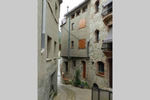 un callejón entre dos edificios en una ciudad en Guesthouse "La Gloria de Arbolí" en Arboli