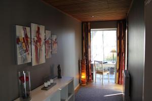 a living room with paintings on the wall at Green Hill Apartment Overijse in Overijse