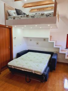 a bedroom with a bed in a room with stairs at Juliana Apartment Bohinj Lake in Bohinj