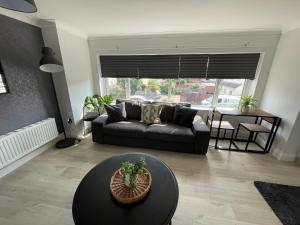 a living room with a couch and a table at Great for contractors- free parking in Southampton