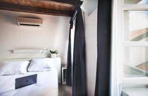 a bedroom with two beds and a laptop on the bed at Urban Hotel Design in Trieste +40 photos