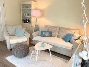 a living room with a couch and a table at Beach Home in Sankt Peter-Ording