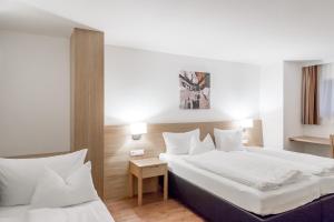 Postel nebo postele na pokoji v ubytování Apart Hotel Garni Wieser