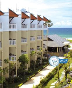 a view of a hotel with the ocean in the background at Karon Princess Hotel SHA EXTRA Plus in Karon Beach