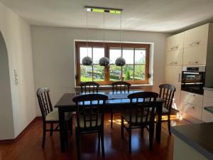 a kitchen with a dining room table and chairs at Ferienwohnung Siglreitmaier 2 in Chieming