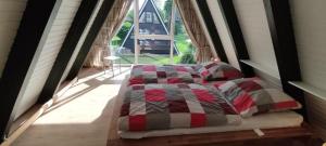 a bed in a room with a large window at Ferienpark Fedderwardersiel in Butjadingen