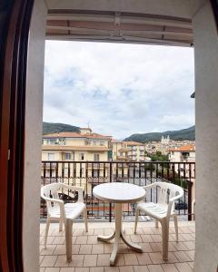 a table and chairs on a balcony with a view at Residence Cherie in Borgio Verezzi