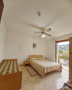 a bedroom with a bed and a ceiling fan at Residence Cherie in Borgio Verezzi