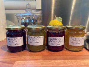 four jars of jam on a counter with a lemon at Le chemin de la Loire in Amboise
