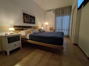 een slaapkamer met een groot bed en een nachtkastje bij Civico10 Polignano in Polignano a Mare