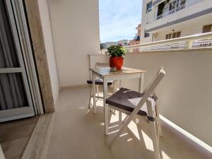een tafel en stoelen op het balkon van een appartement bij Civico10 Polignano in Polignano a Mare