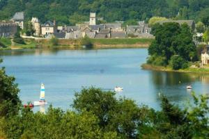a group of boats on a large river with a town at La roseraie de L arguenon, spacieux appartement centre ville in Jugon Les Lacs +2 photos