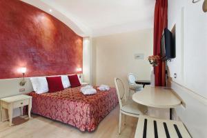 Postel nebo postele na pokoji v ubytování Hotel Royal-Spiaggia