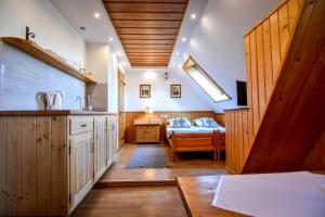 a kitchen with a sink and a bed in a room at U Króla in Kościelisko +155 photos