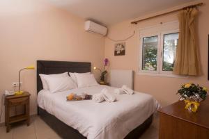 a bedroom with a bed with towels on it at Filoxenia Hotel in Volos