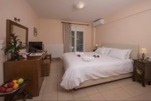 a bedroom with a bed with a stuffed animal on it at Filoxenia Hotel in Volos