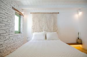 Voodi või voodid majutusasutuse Levantes Ios Boutique Hotel toas
