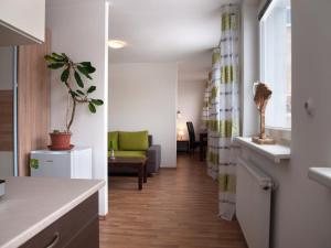 a room with a hallway with a couch and a table at Penzion Malina in Hronská Dúbrava