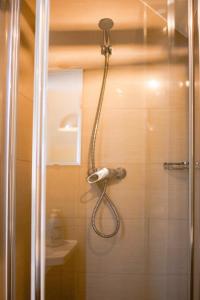 a shower with a shower head in a bathroom at Nadmorski in Żarnowska