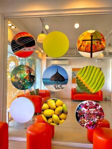 a window of a store with colorful plates and chairs at Islands Stay Hotels Mactan in Mactan