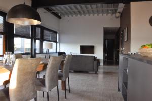 a kitchen and dining room with a table and chairs at Dock Hotel Stellendam in Stellendam