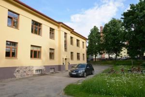a car parked in a parking lot next to a building at Baumanis apartamenti in Valmiera