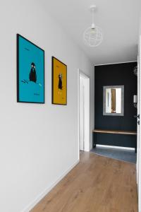 a living room with three paintings on the wall at Otwock PREMIUM Apartment- CENTRUM PKP in Otwock