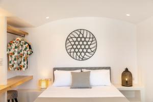 1 dormitorio con 1 cama con sábanas blancas en Naxos DownTown Apartments & Suites, en Naxos Chora