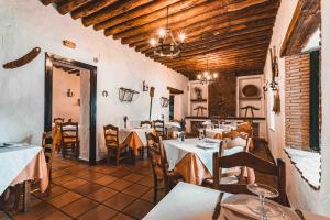 a restaurant with tables and chairs in a room at El Horcajo in Montecorto