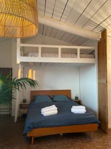 a bedroom with a bed with two pillows on it at sous les toits de st tropez in Saint-Tropez