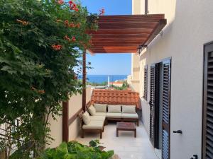a patio with a couch and a table at Luigi apartments in Dubrovnik
