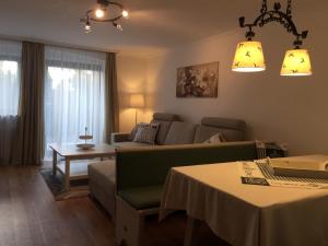 a living room with a couch and a table at Ferienwohnungen Gästehaus Sonnenkreis in Ruhpolding