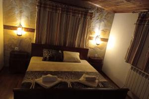 a bedroom with a bed with two pillows on it at Семейна къща Лазарови in Sapareva Banya